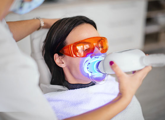 Woman undergoing teeth whitening treatment